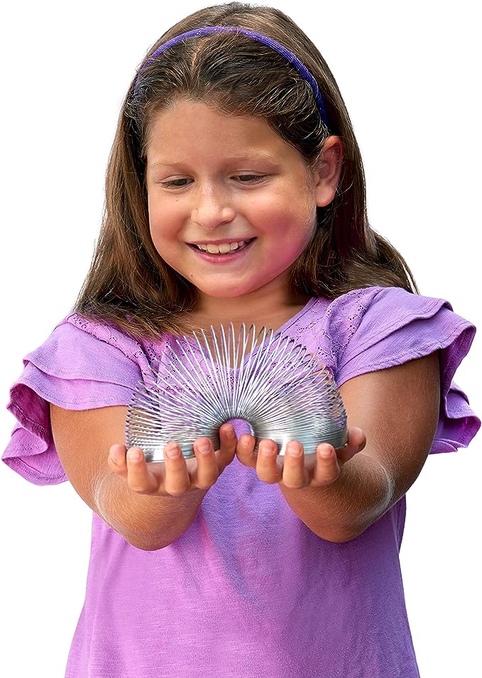 A girl playing with Classic Slinky